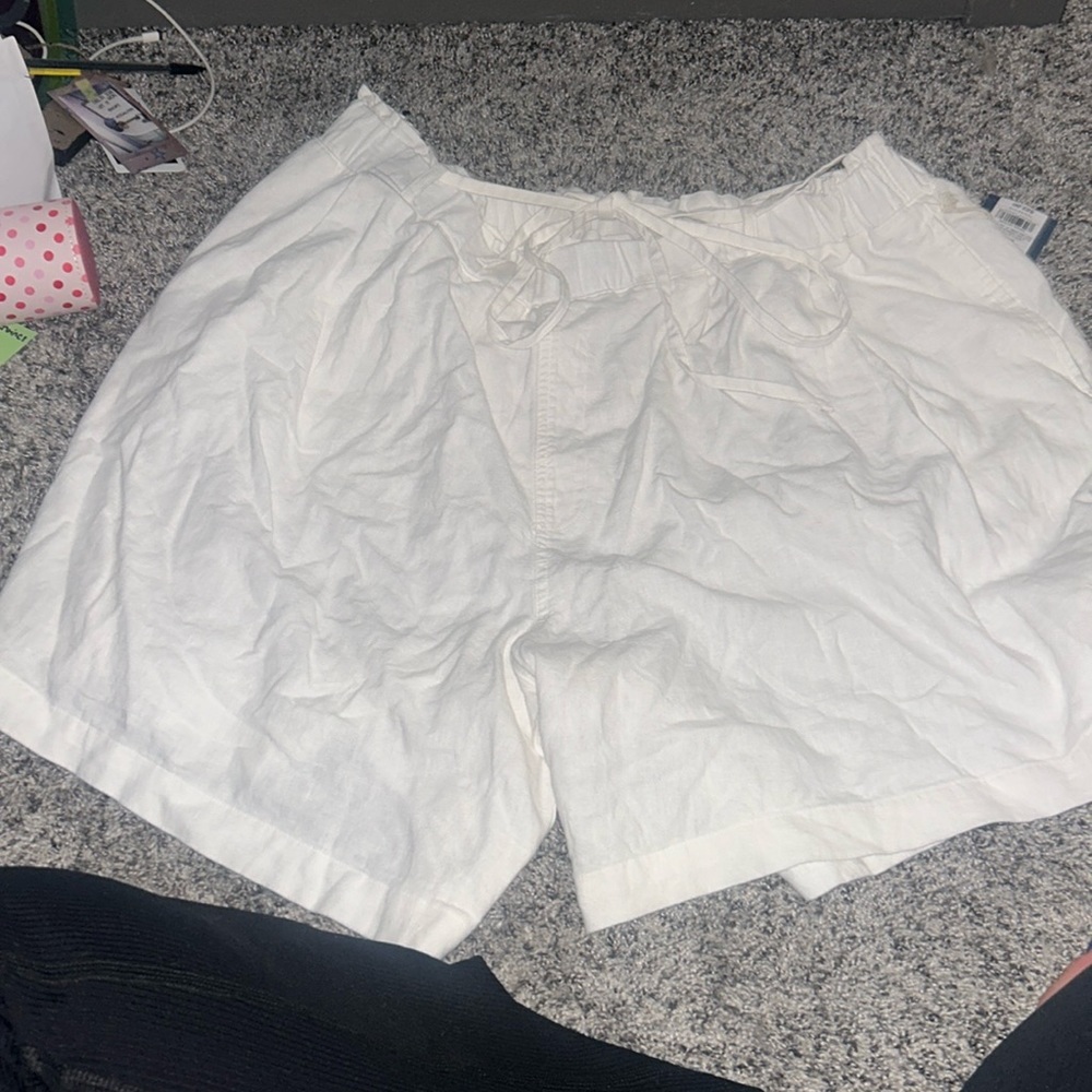 white shorts with a wrap around tie that can make a bow in belt straps